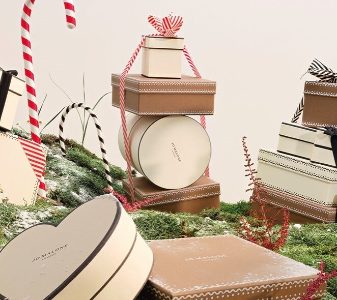 Jo Malone London stacked gingerbread themed Christmas boxes with stripped ribbon and candy canes